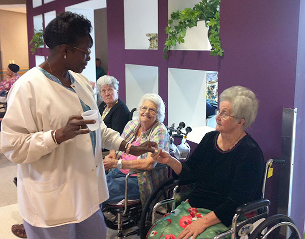 caregiver giving resident a drink